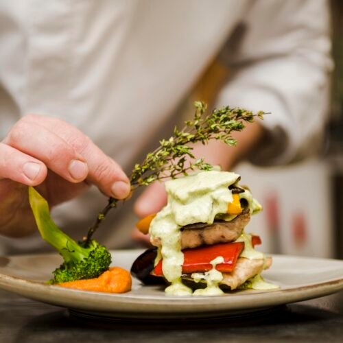 chef-placing-herb-gourmet-meal