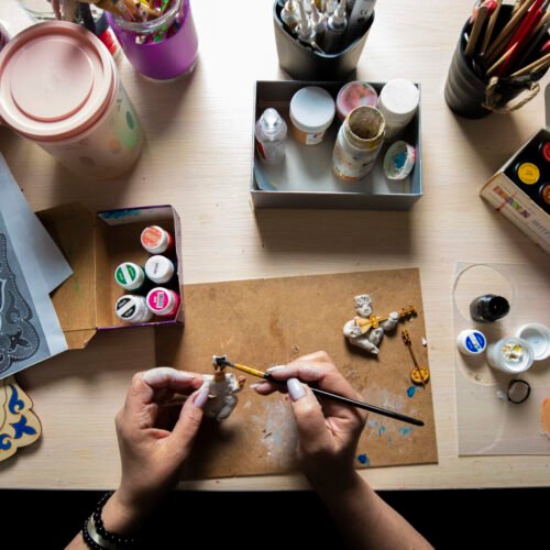 Master painting mini figures with brush. High quality photo