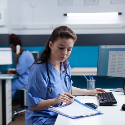 Pharmacist nurse with stethoscope analyzing healthcare treatment on medical documents typing sickness expertise working in hospital examination office. Woman asisstance checking disease results